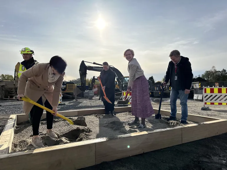 A group of people shoveling dirt